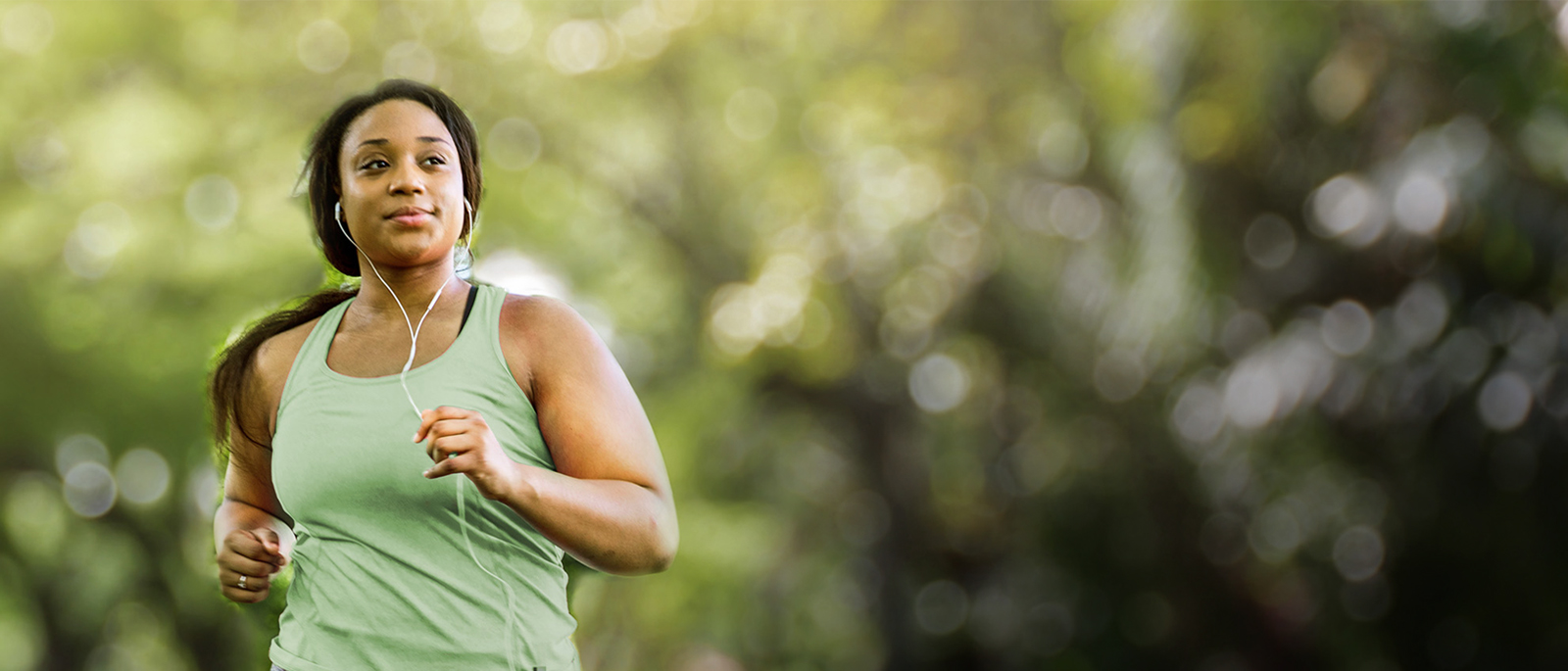 a woman in a green shirt running