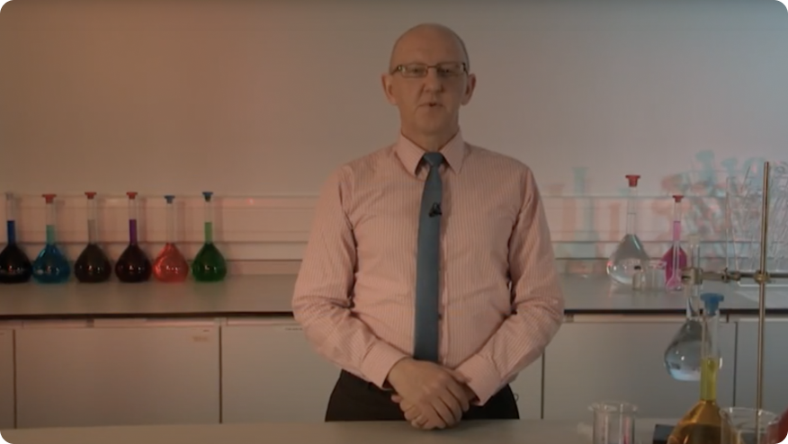 a person standing in front of a counter with bottles of alcohol